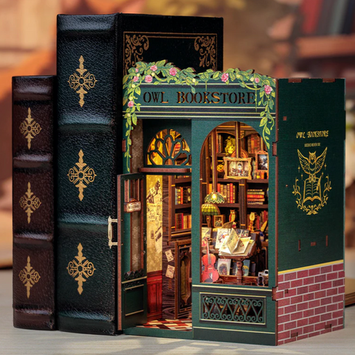 Miniature book-shaped model of an owl bookshop with detailed interior.