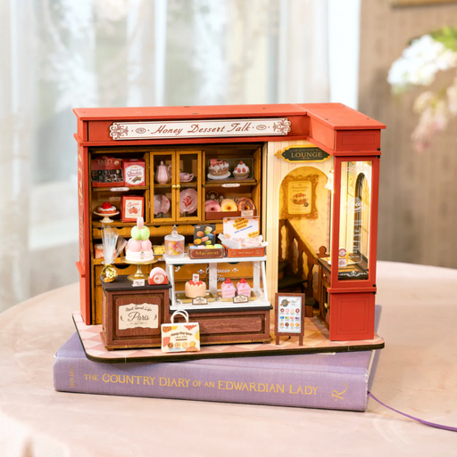 Miniature model of a dessert shop on top of a book